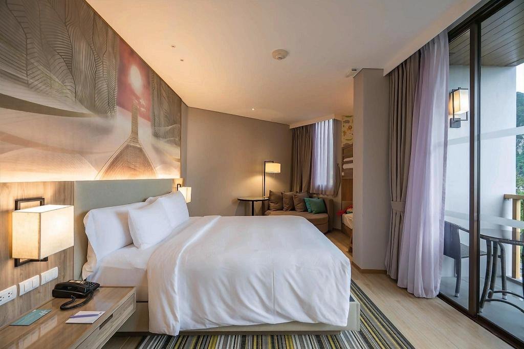 Bedroom with balcony doors at Holiday Inn Resort