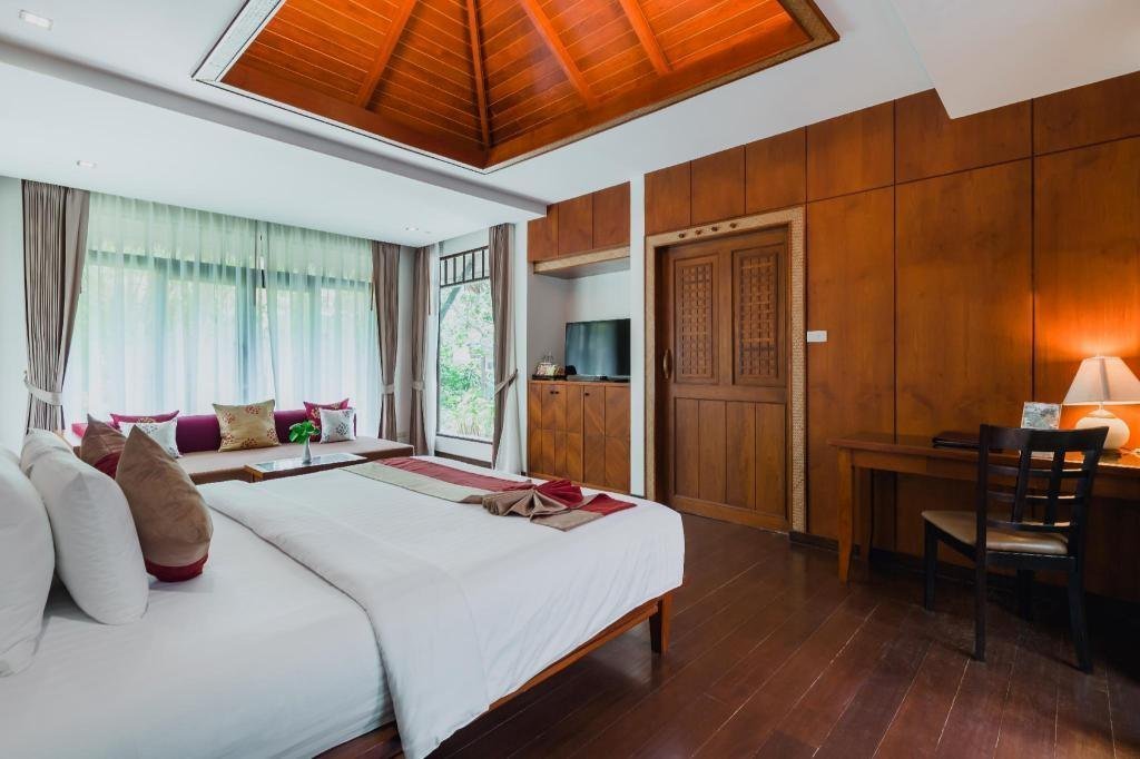 Bedroom with wooden fittings at Railay Village Resort