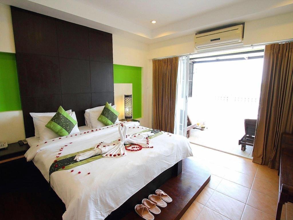 Bedroom and window at Royal Nakara Ao Nang Hotel