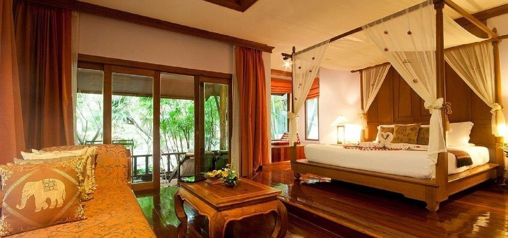 Bedroom with wooden furnishings at Sand Sea Resort