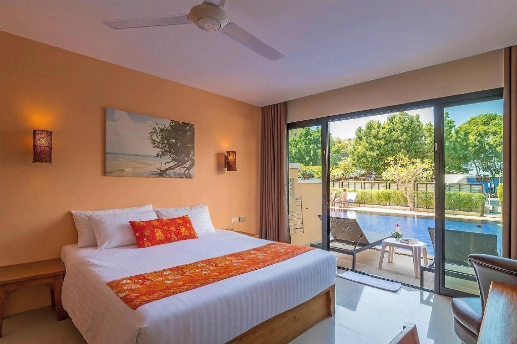 Bedroom with balcony at Srisuksant Resort