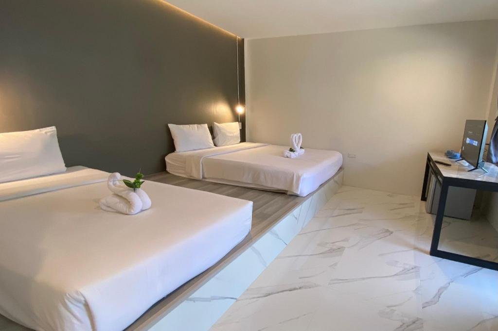 Two beds on a raised platform in a room at The Dream Garden